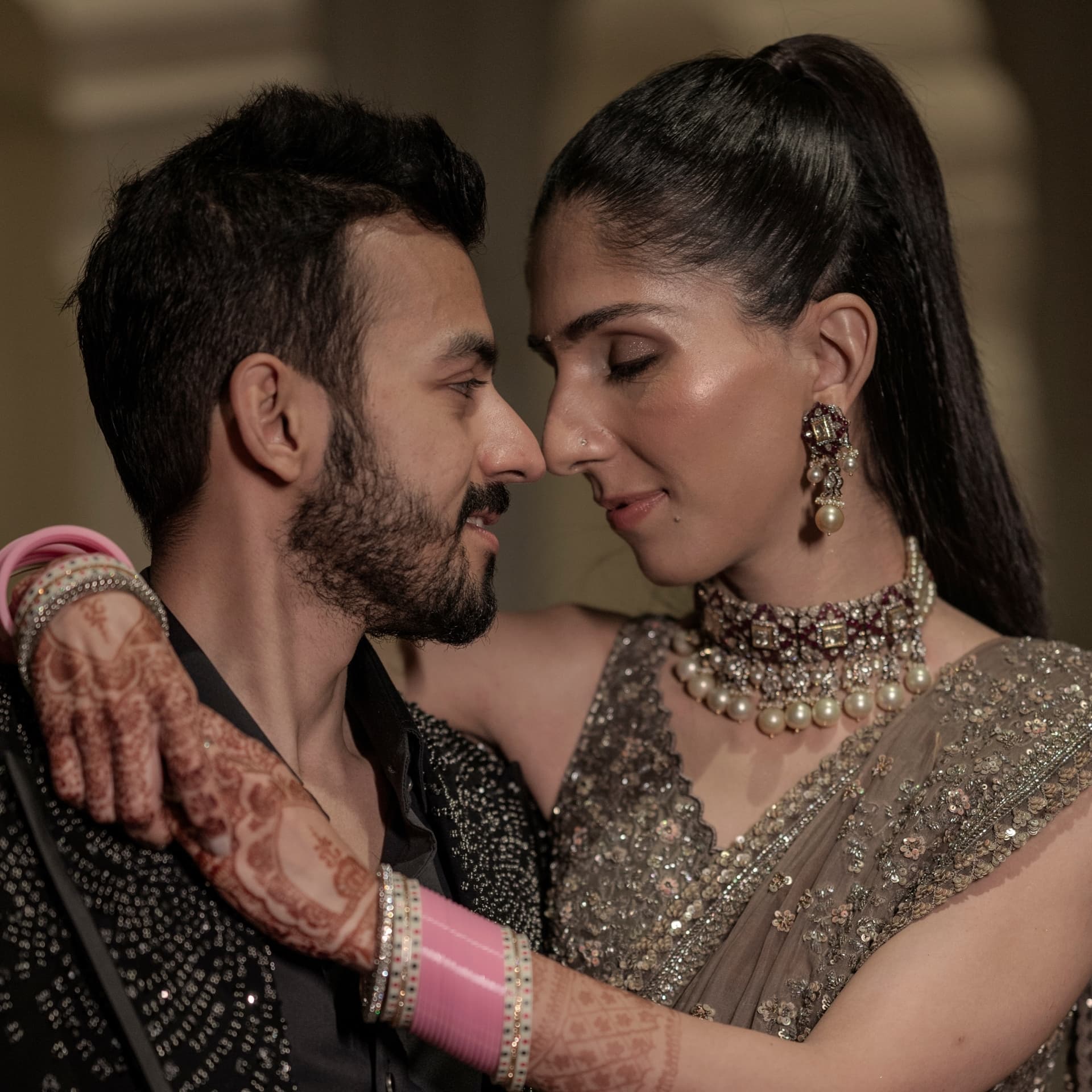 A couple close together in jewellery and silk