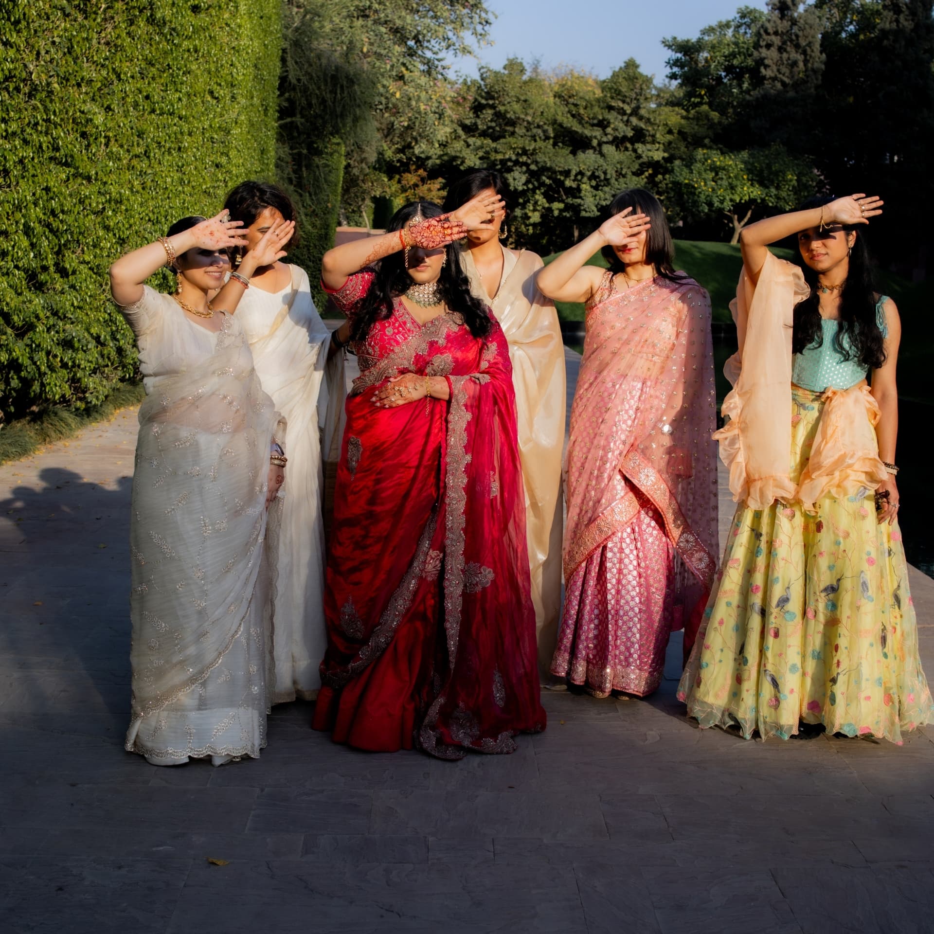 The bridal party shielding their eyes in evening light