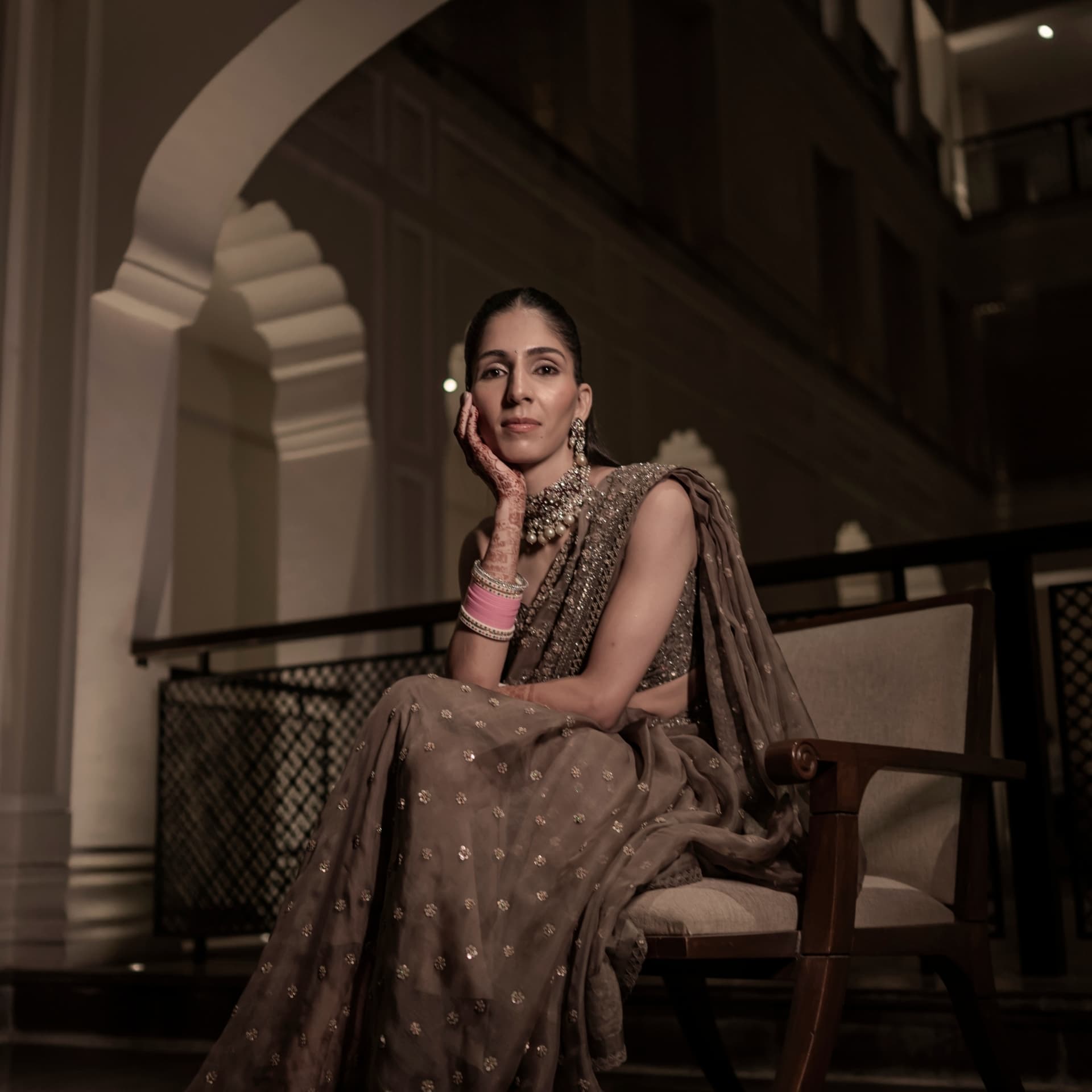A bride seated in low evening light