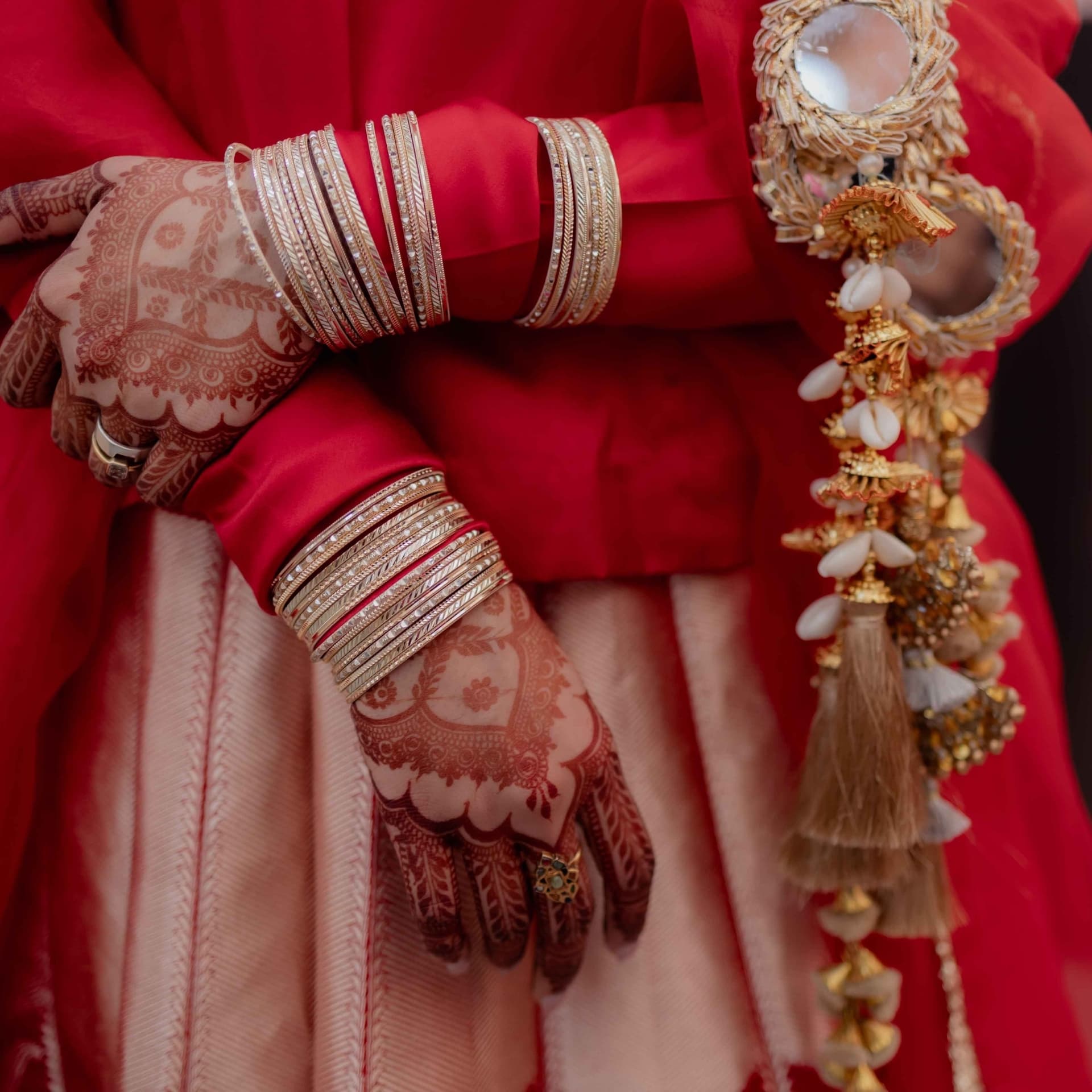 Hennaed hands and stacked bridal bangles