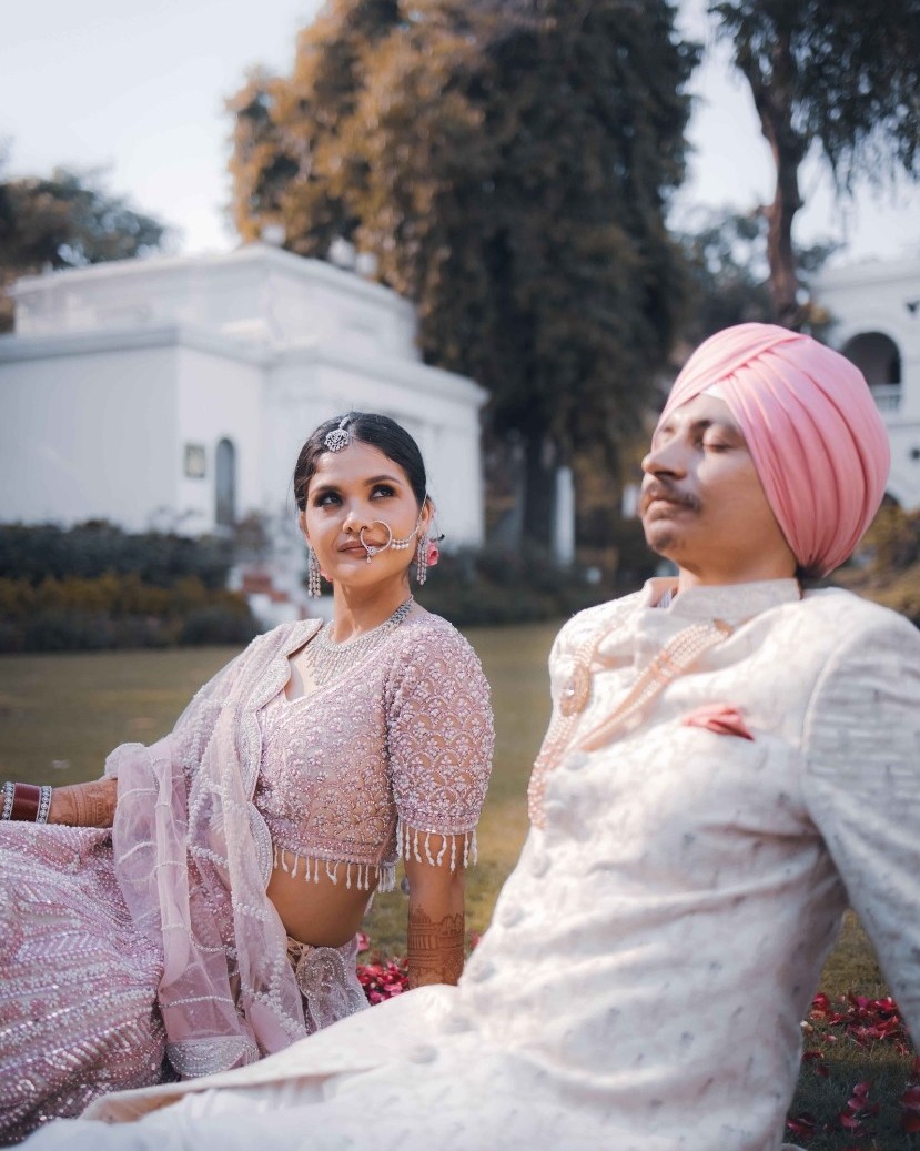 A bride and groom seated together outdoors